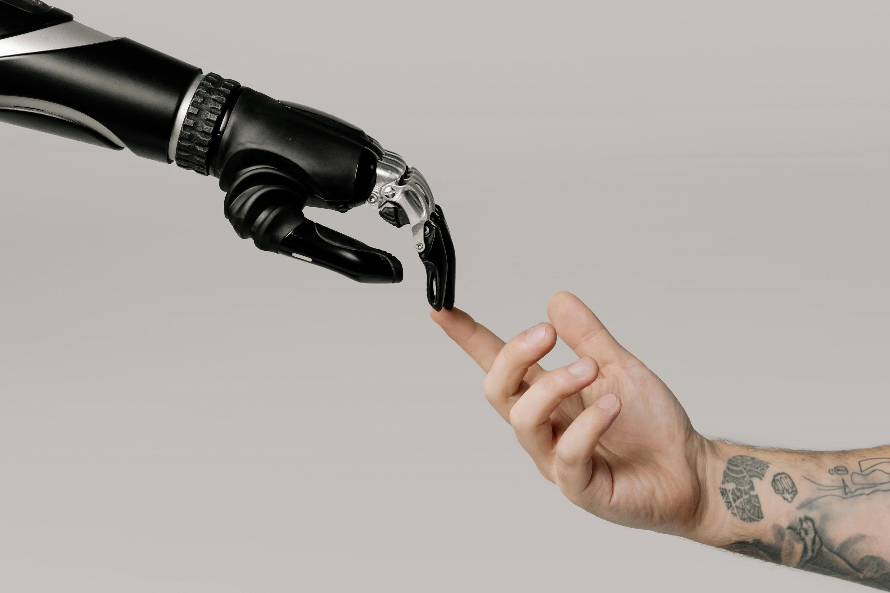 robot hand reaches for a human hand