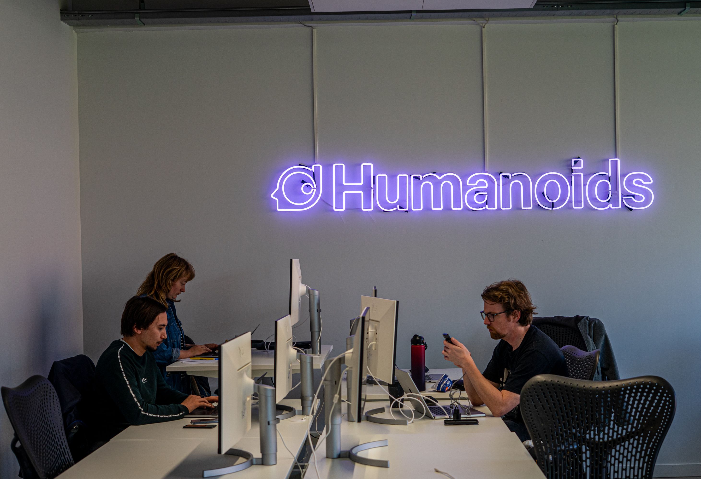 Drie deelnemers aan het werk tijdens de AI & Conversational Hackathon bij Humanoids.